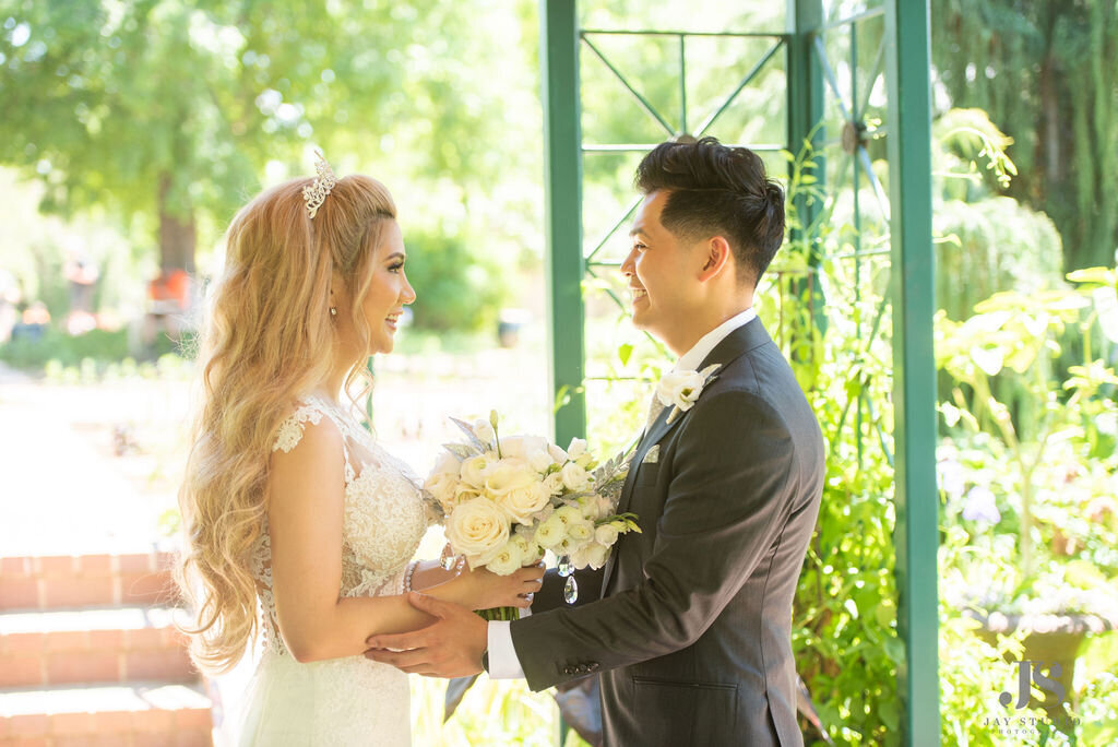 Bride and groom before the ceremony with a white bouquet  at the Denver Botanic Gardens.