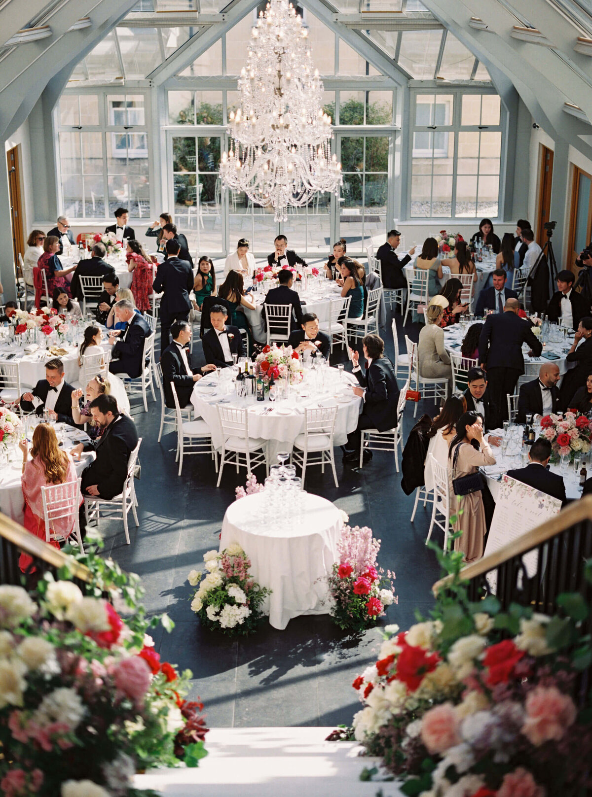 wedding guests sitting at the reception room at botleys mansion and enjoying their time