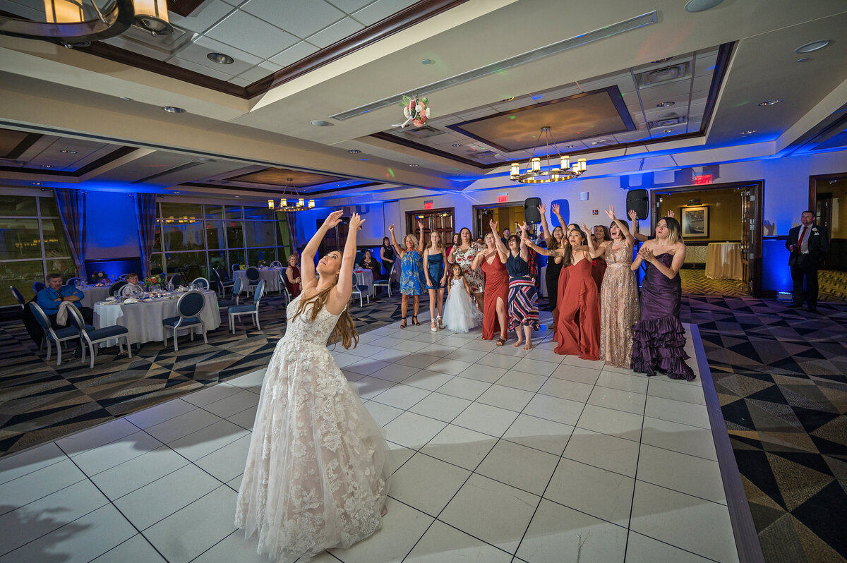 Wedding bouquet toss during reception at Sheraton Erie Bayfront Hotel.