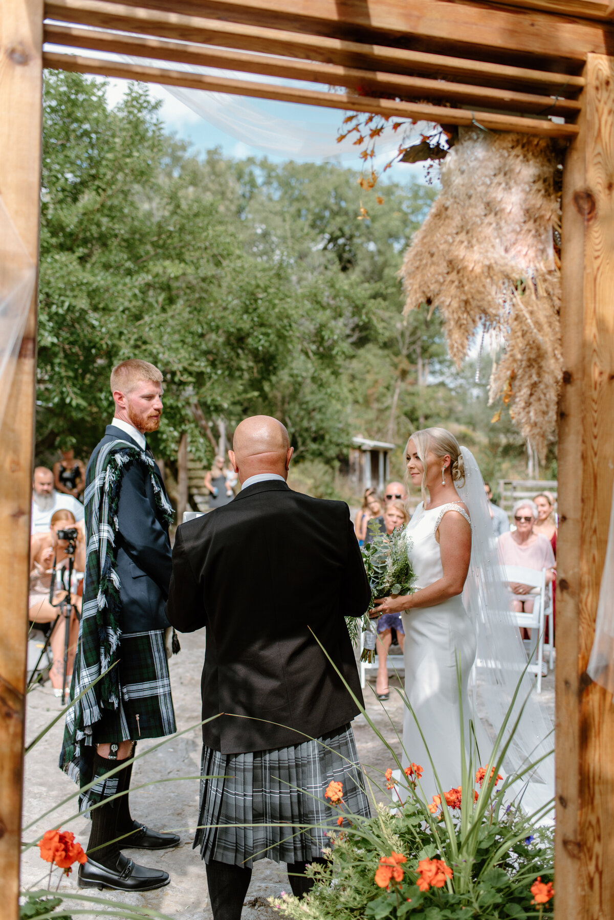 hamilton ontario wedding bride and groom say vows at outdoor ceremony