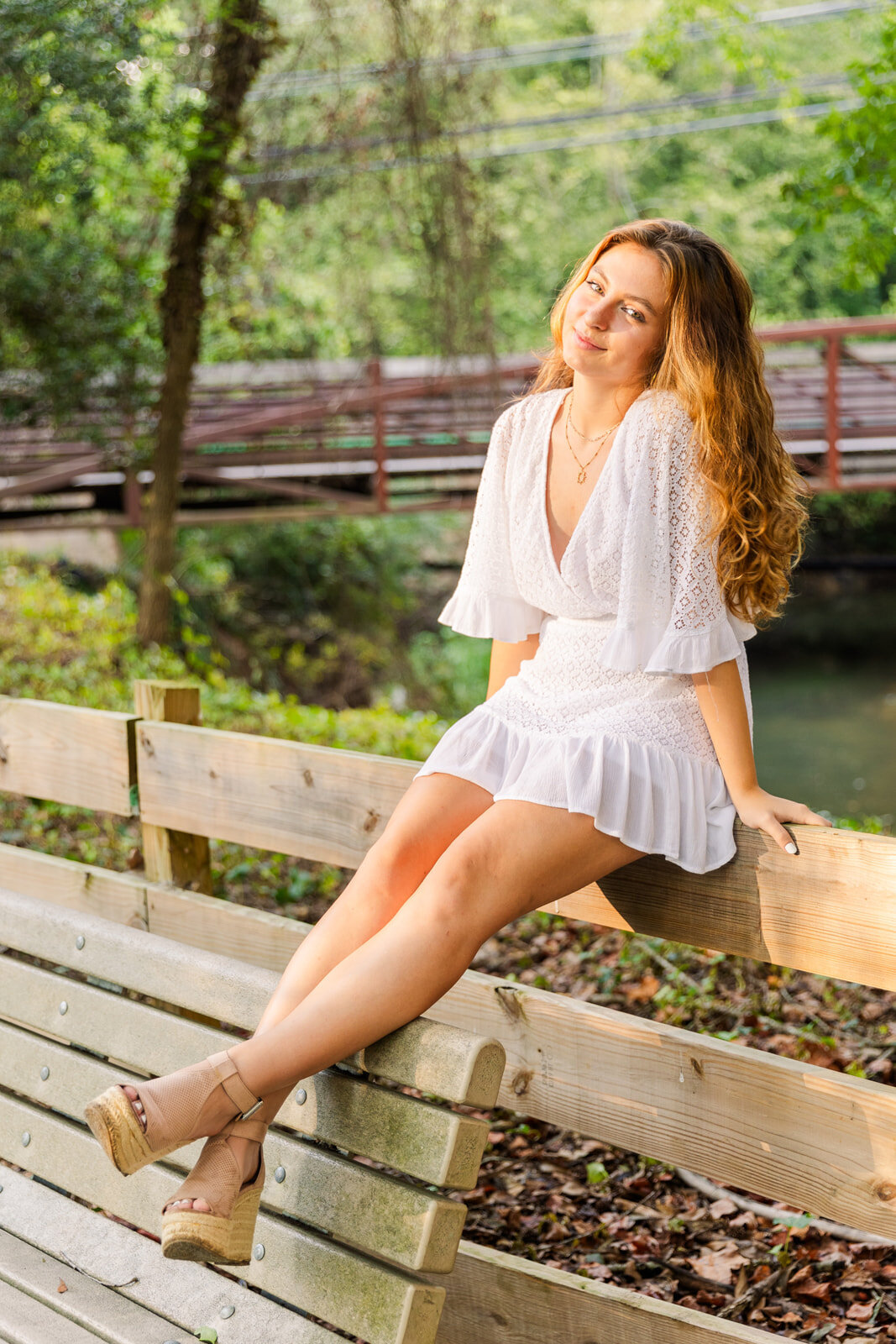 Atlanta outdoor summer high school girl sitting on a fence wearing white dress portraits Laure photography