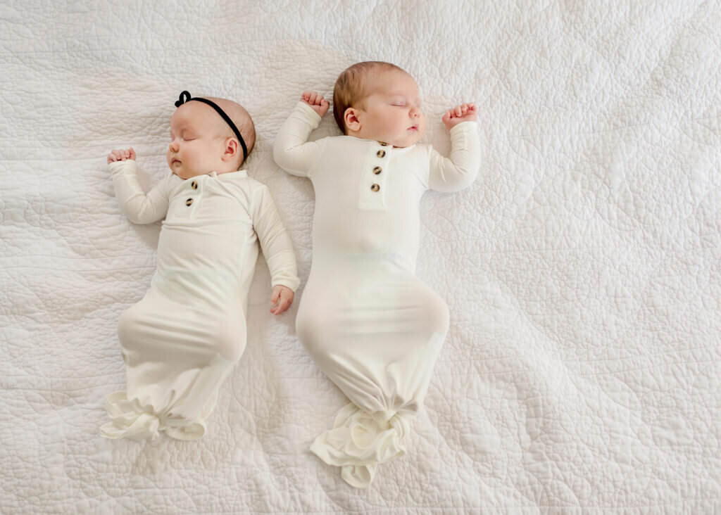 twin newborns on bed
