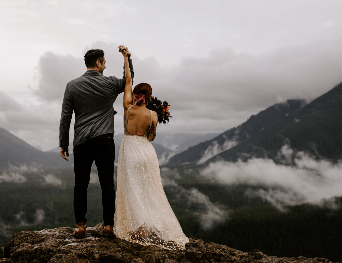 Couple celebrates after eloping on the summit of rattlesnake ridge