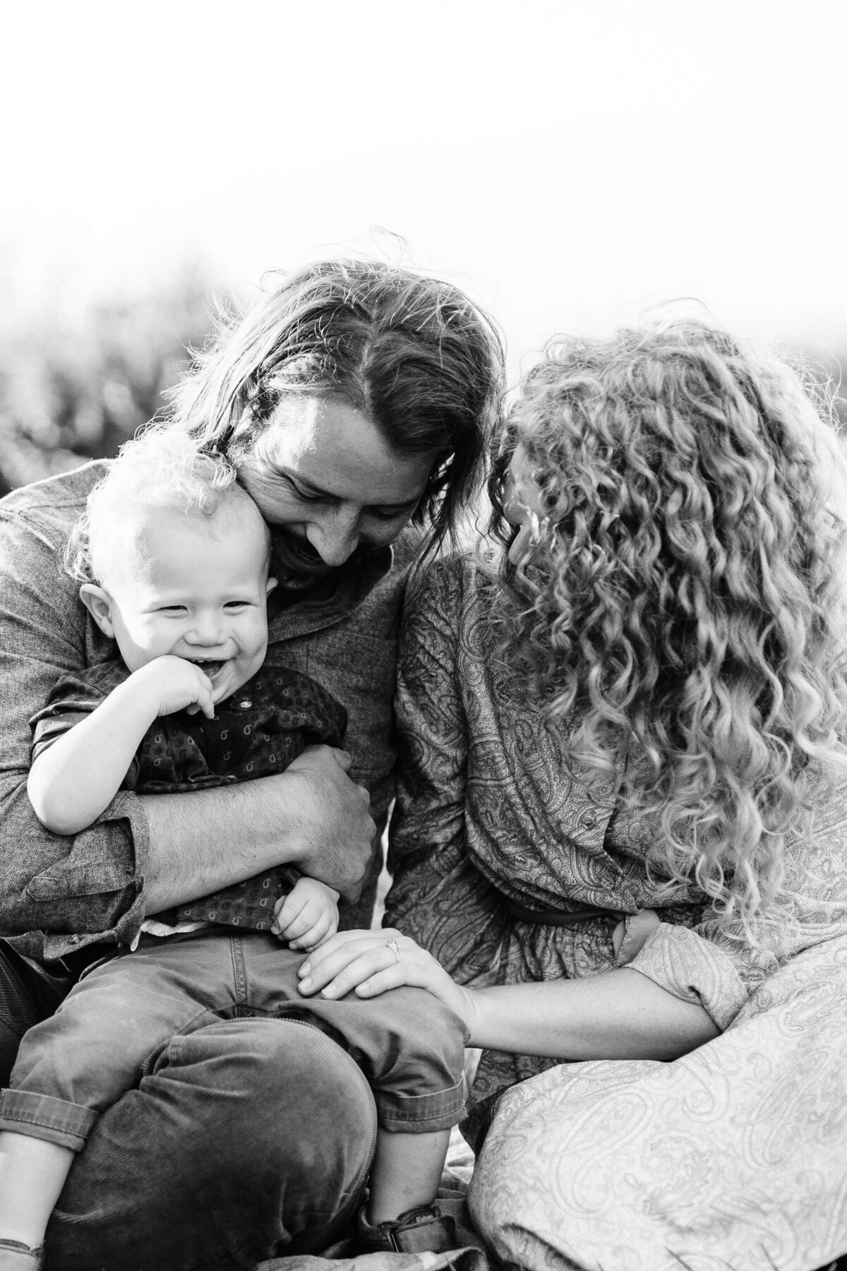 B&W photo of family having a sweet moment together