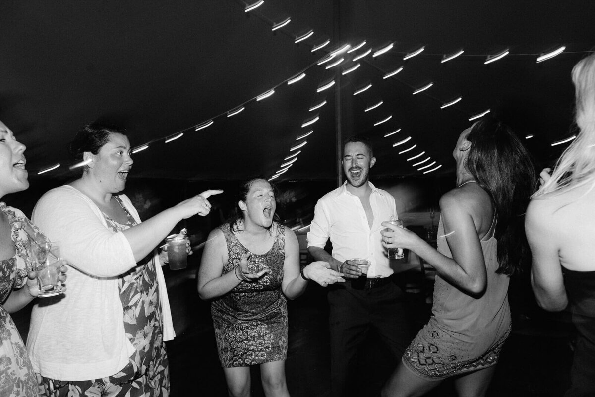Black and white photo of the wedding guests partying at Cape Cod Summer Tent in Osterville, MA.