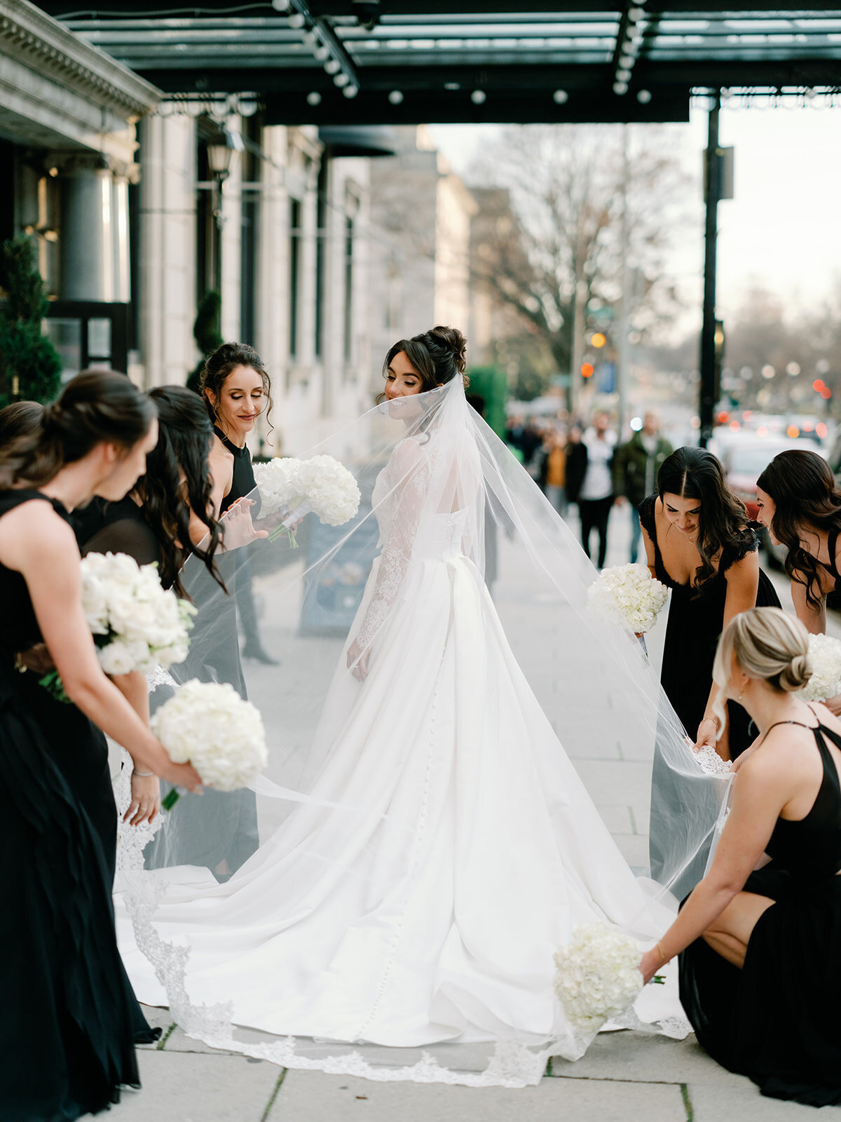 Bride and bridesmaids in front of hotel washington