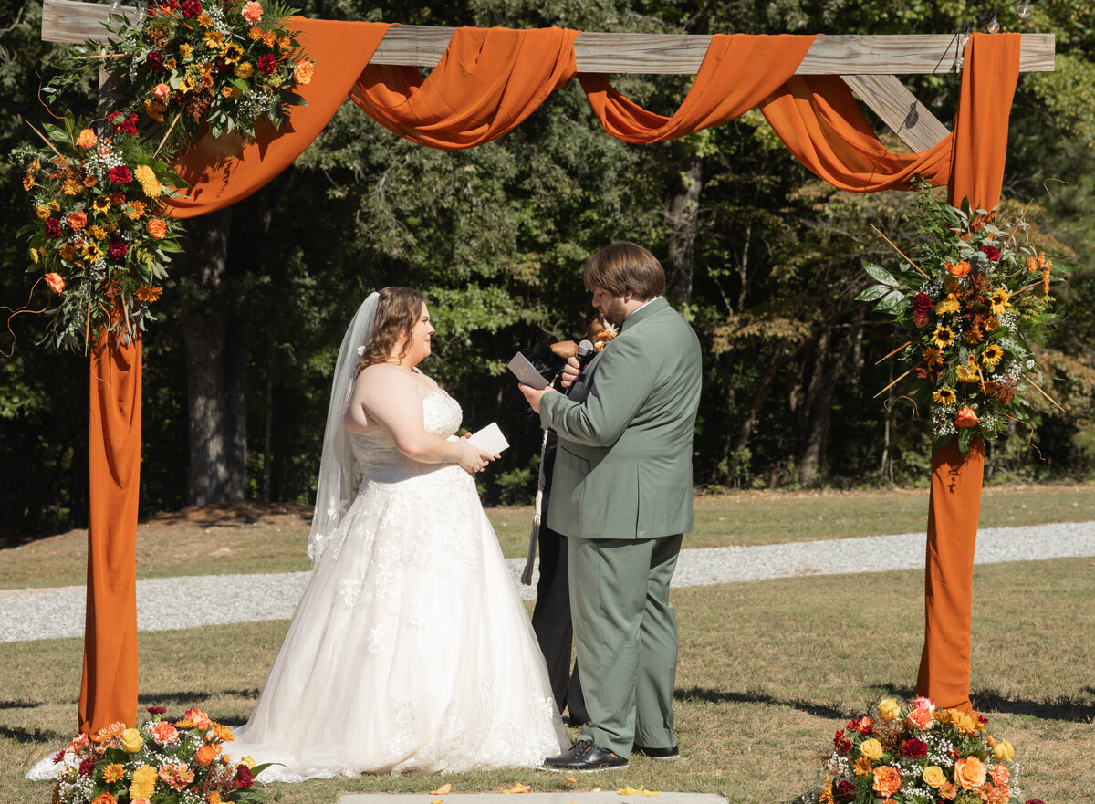 bride-and-groom-saying-vows-at-the-hidden-cabin-seale-alabama