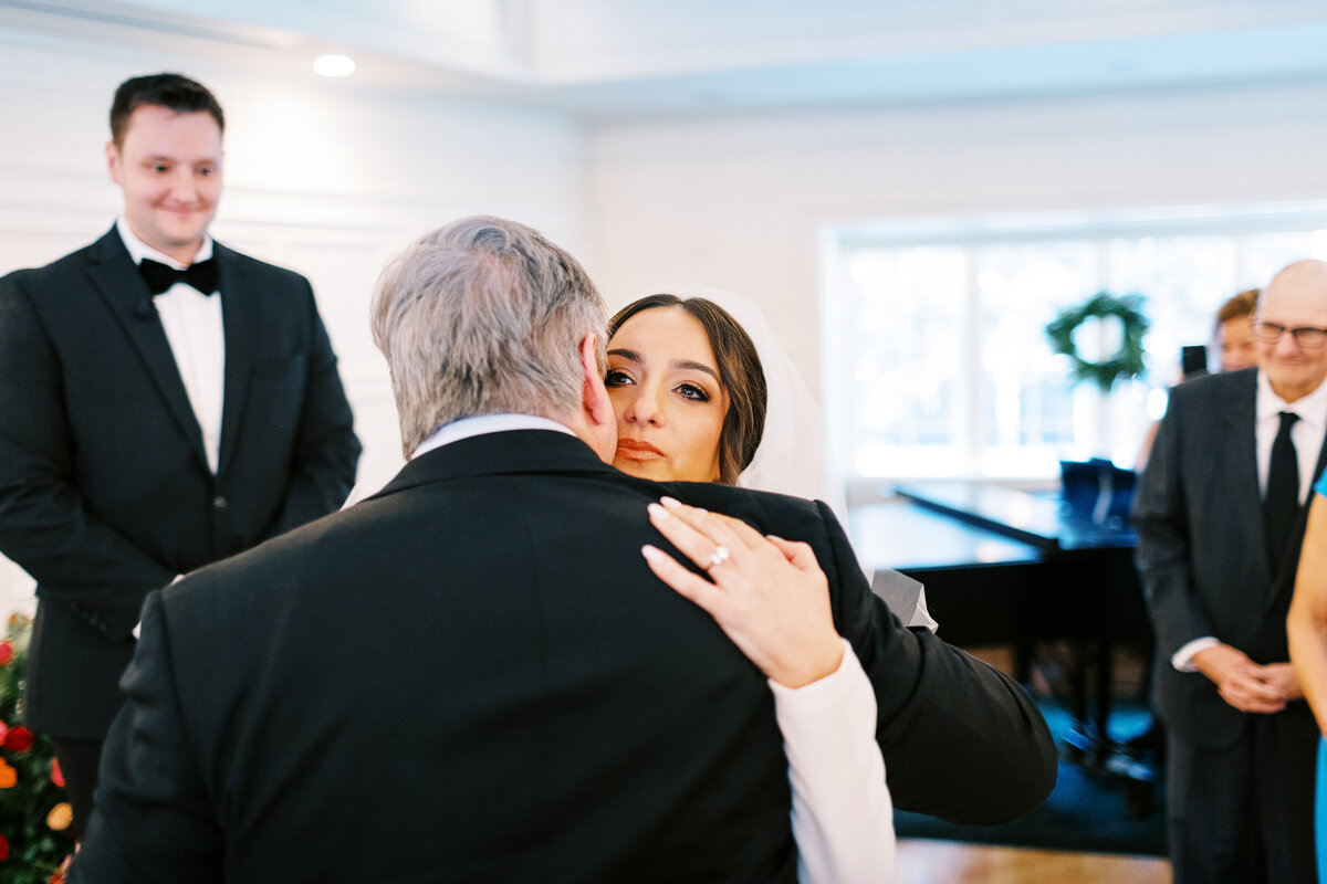 Minnesota bride hugging her dad at the ceremony.