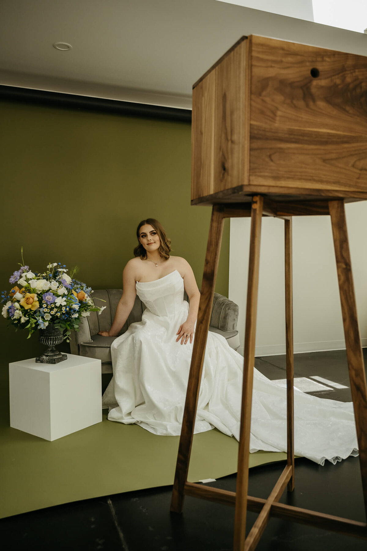 A woman in a wedding dresses poses for the Birdie Booth an open air Eugene photo booth rental.