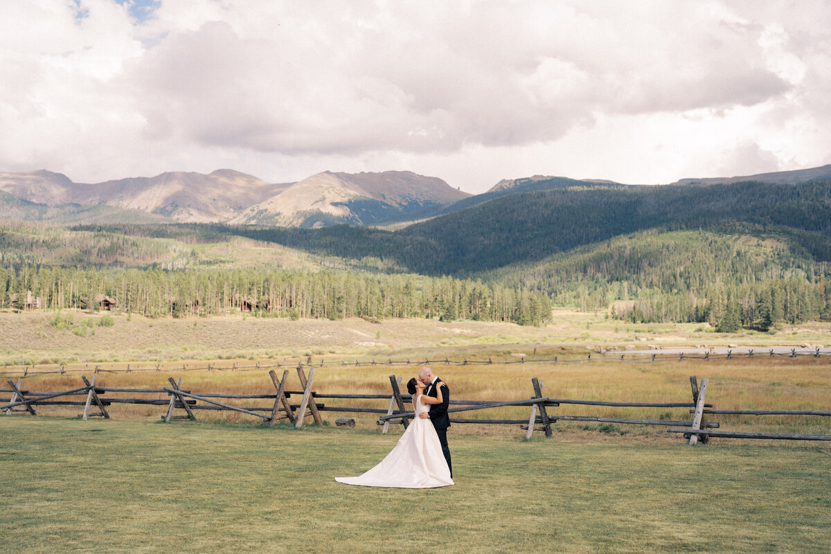 Couple in the field at Devils Thumb Ranch wedding