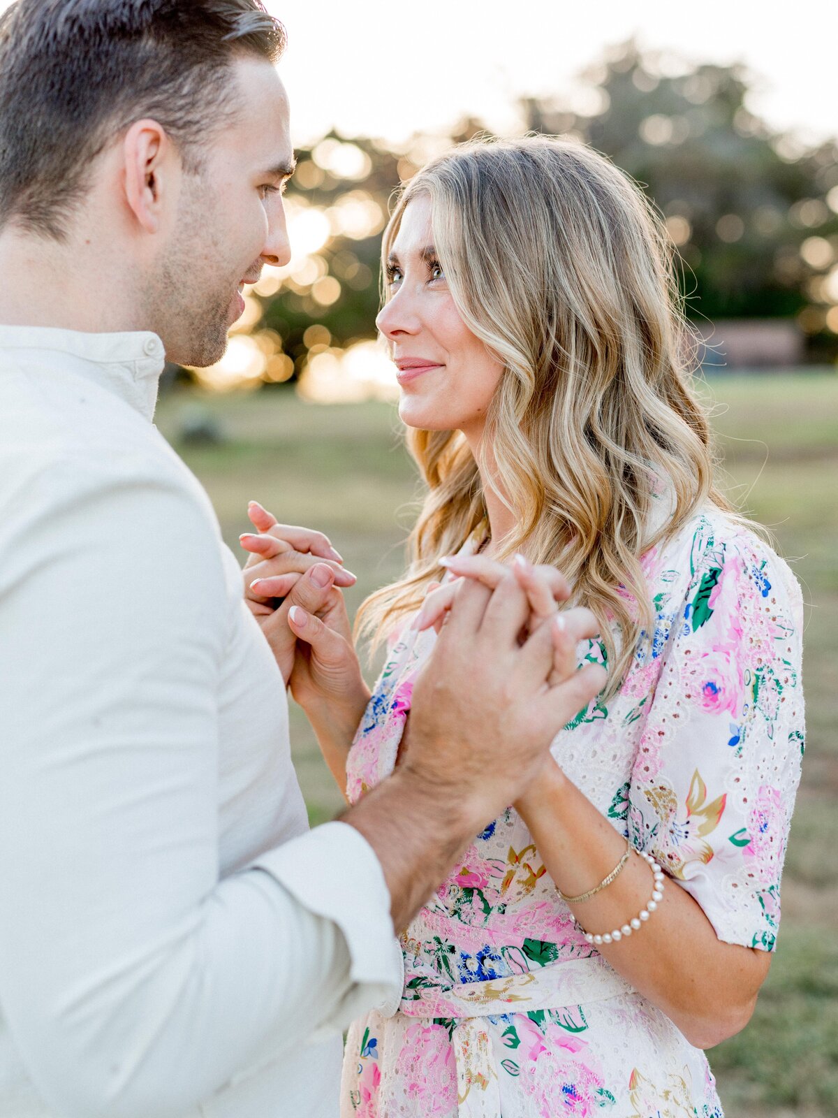 Tender engagement moment in San Luis Obispo—holding hands, sharing a gaze, and soaking in golden hour love.


