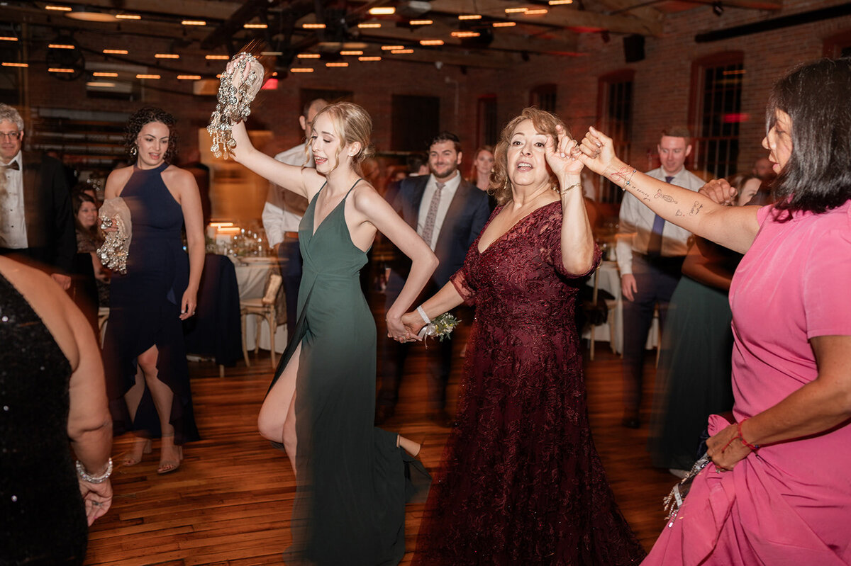 families and guests partake in assyrian dancing at wedding reception