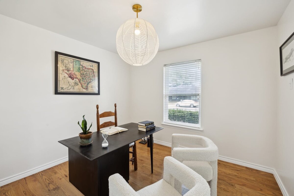 Home office at 3120 Chapel Downs Dr Dallas TX with hardwood flooring, large window, cozy workspace and natural lighting — ideal for remote work, listed by Haven Realty Group.