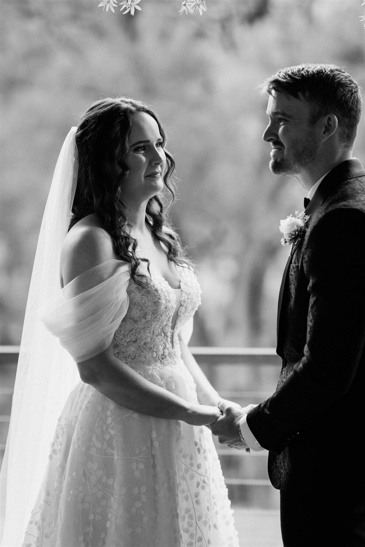 A couple stands lovingly together at the ceremony, radiating happiness and anticipation.