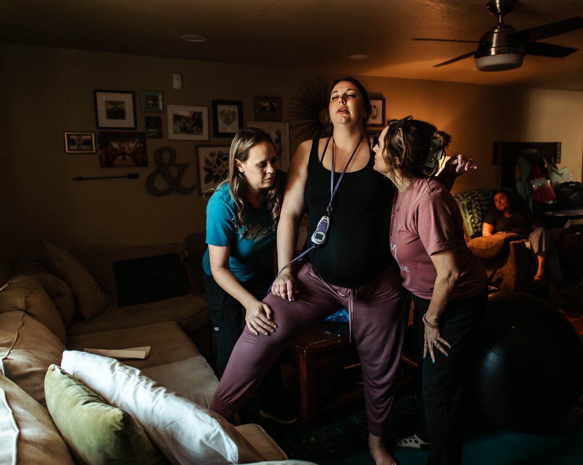 A husband helps support his wife through contractions during labor