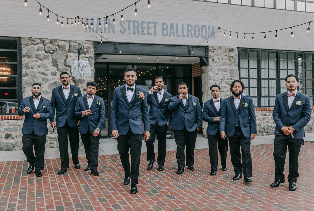 Groom and groomsmen walking outside the venue