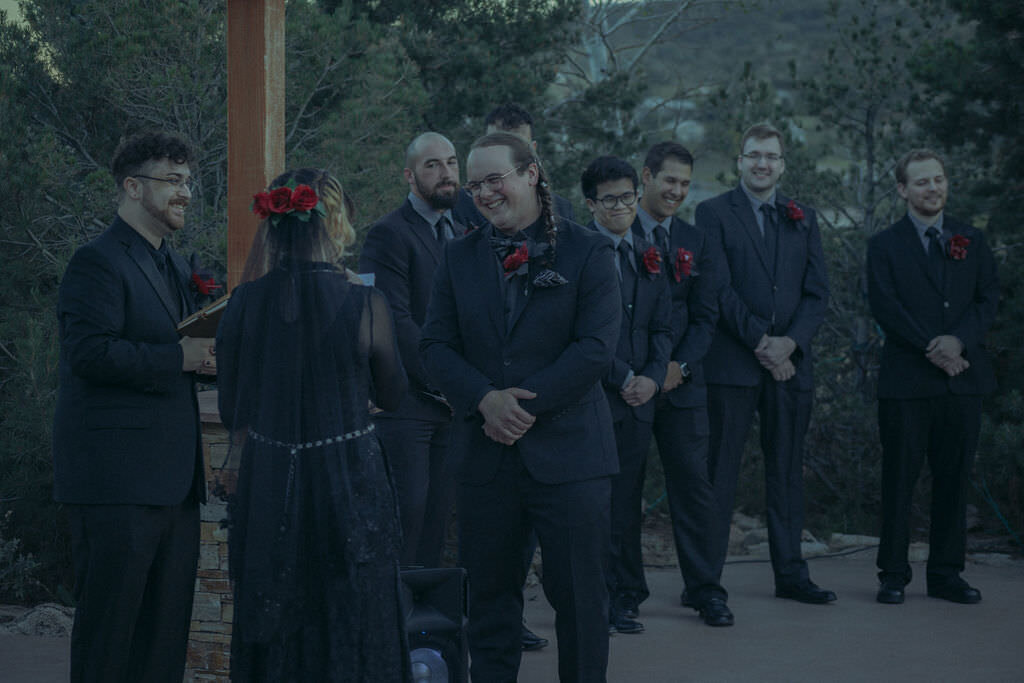 A wedding ceremony with everyone in all black.