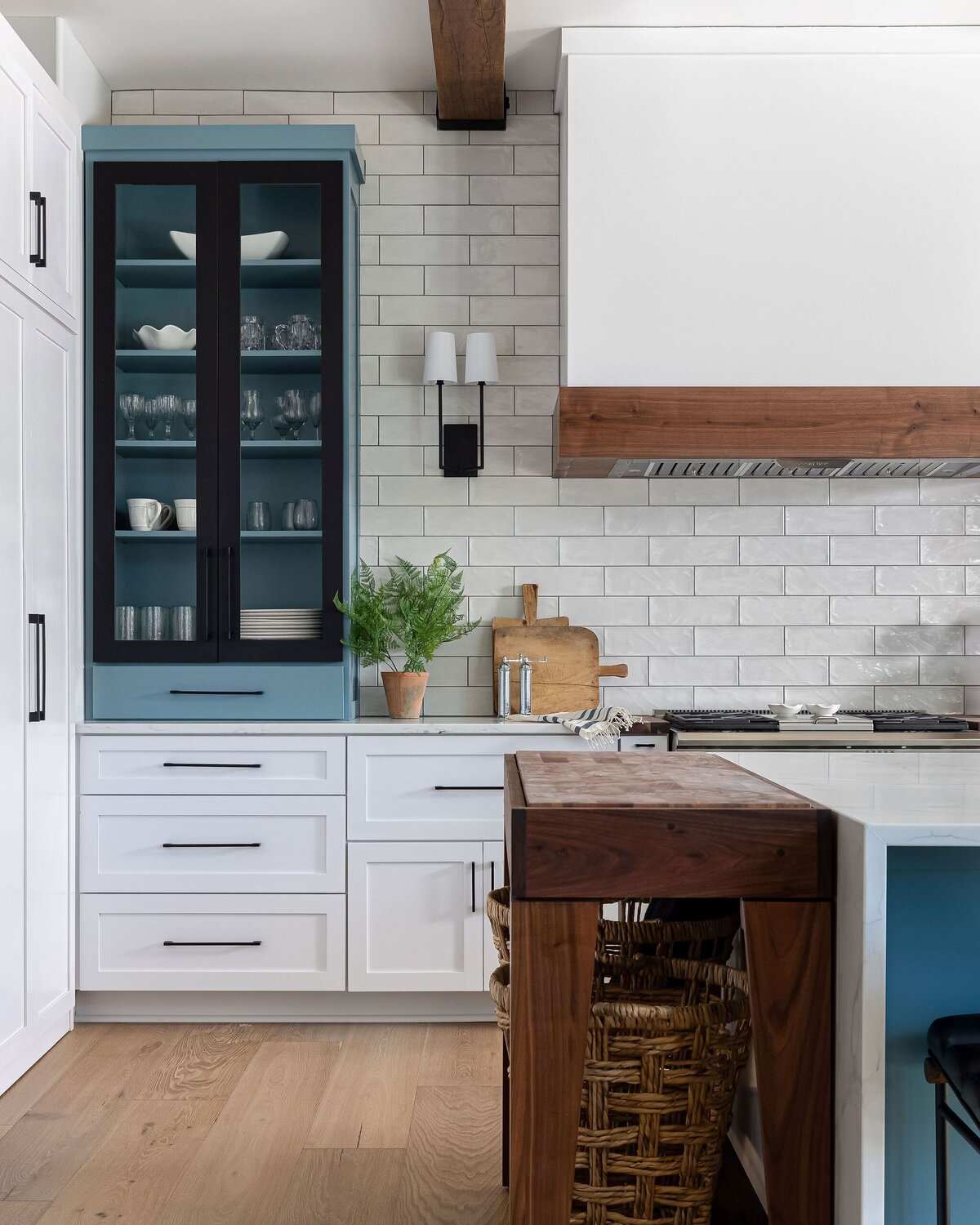 kitchen with blue and white cabinets and custom butcher block table