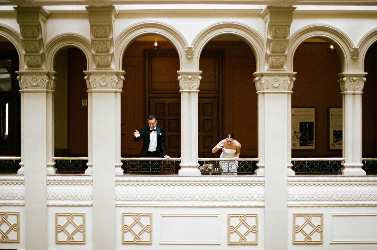 couple overlooking their wedding reception from above