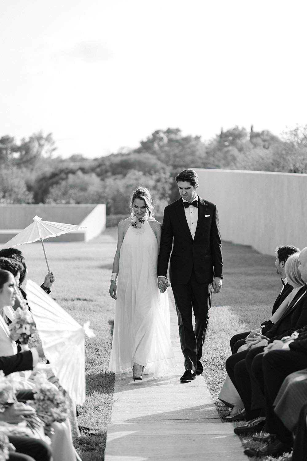groom walking down aisle with mother