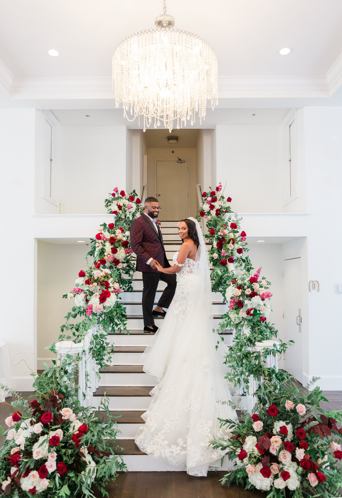 Black bride and groom on belle mer staircase in newport RI