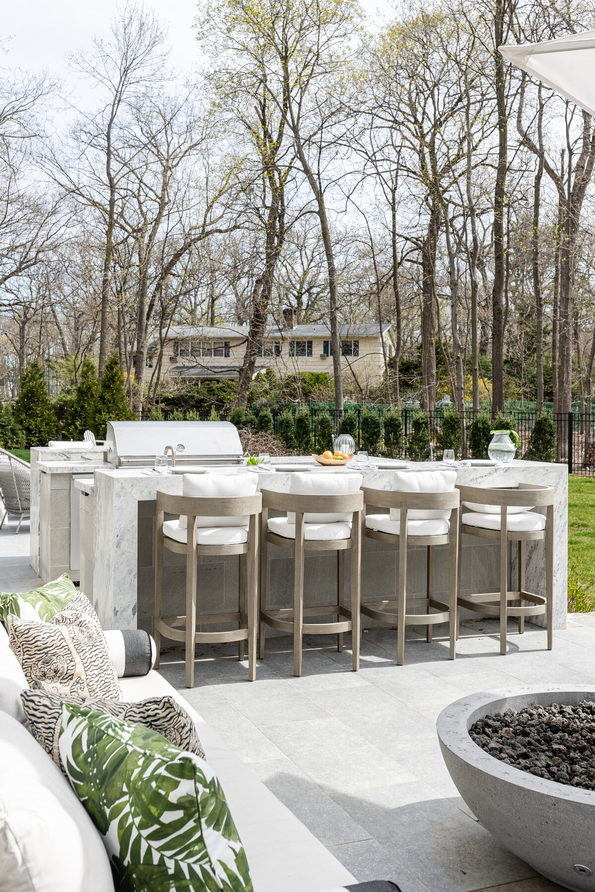 The outdoor kitchen showcases a Princess White Quartzite island/bar.