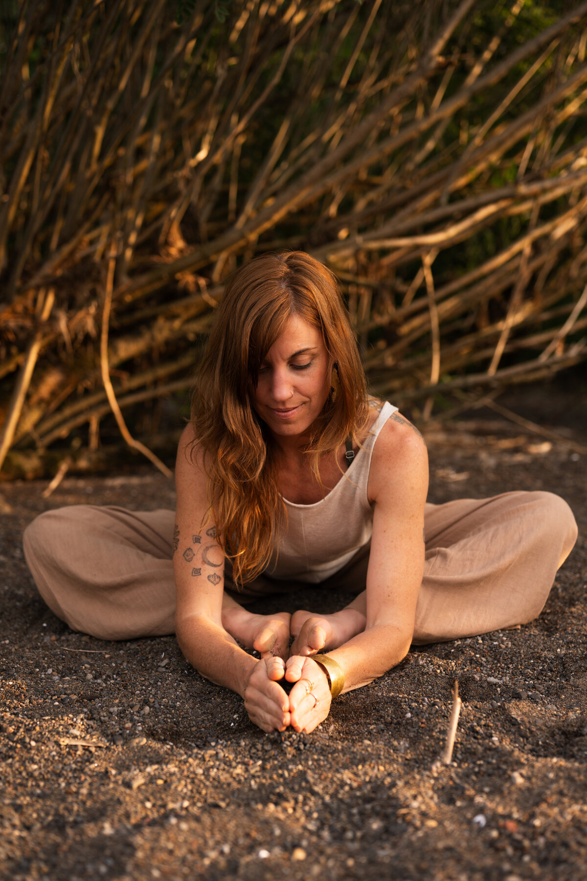 woman doing yoga pose on ground