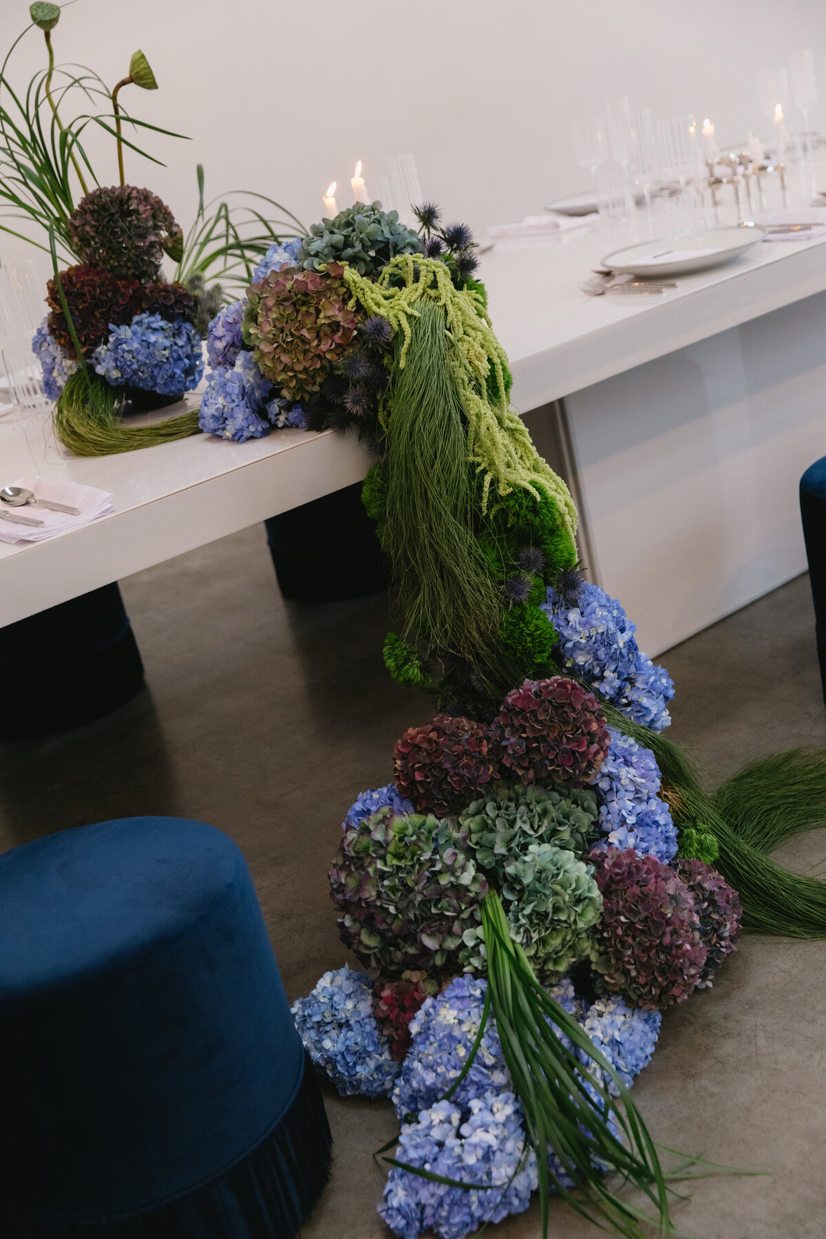 Styled wedding tablescape featuring candles and modern glassware in an upscale New York venue.