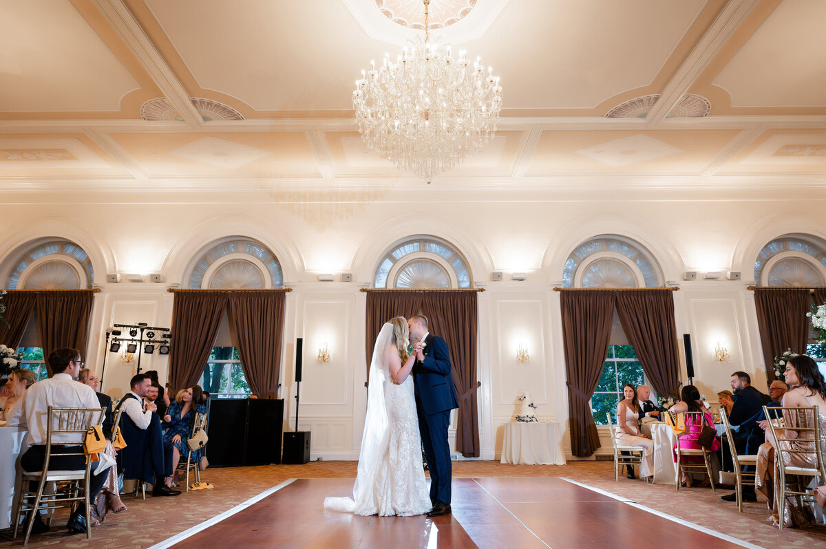 wedding couple dancing their first dance during their wedding reception at the university club