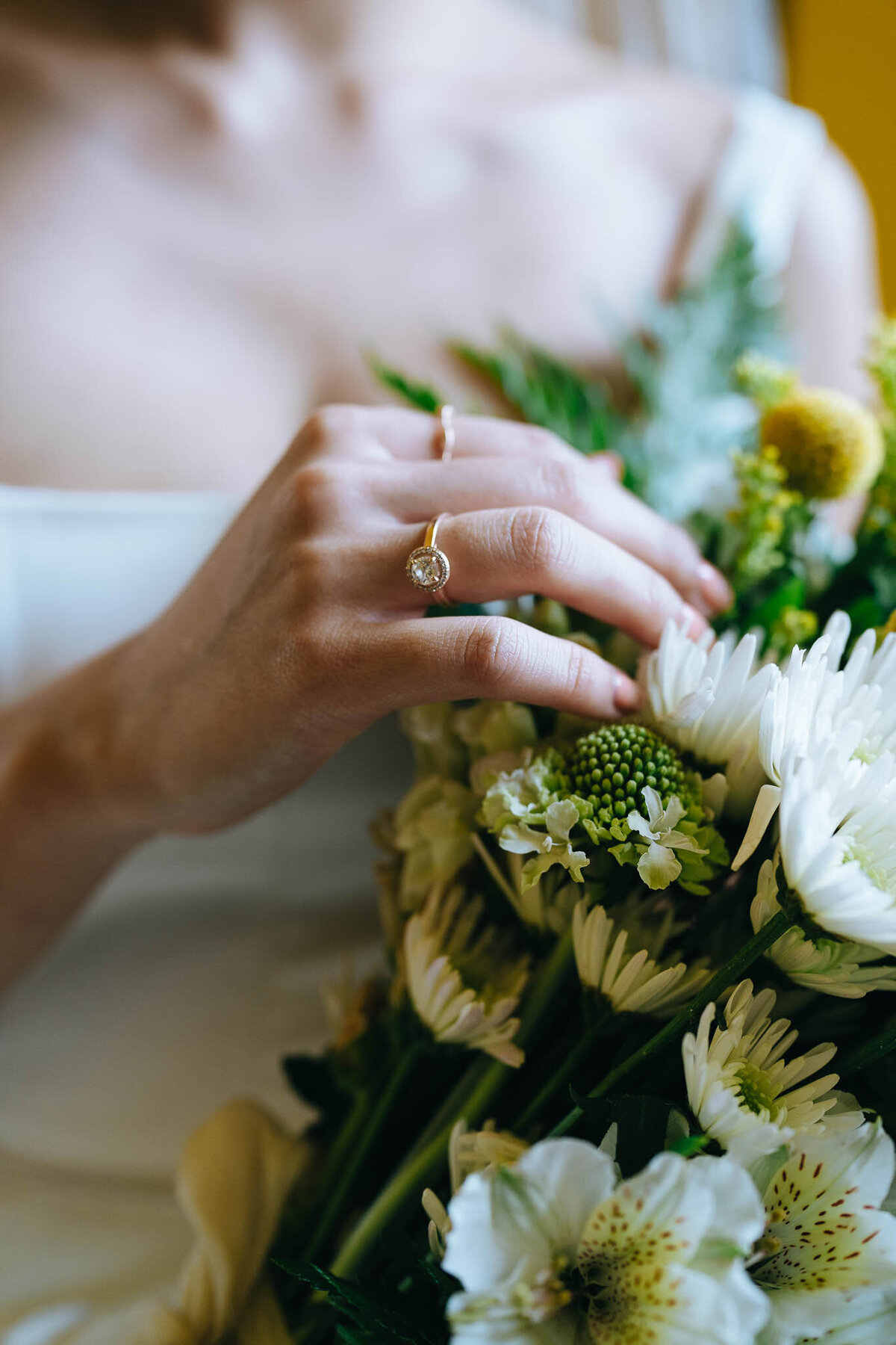 bride holding wedding bouquet showing off engagement ring