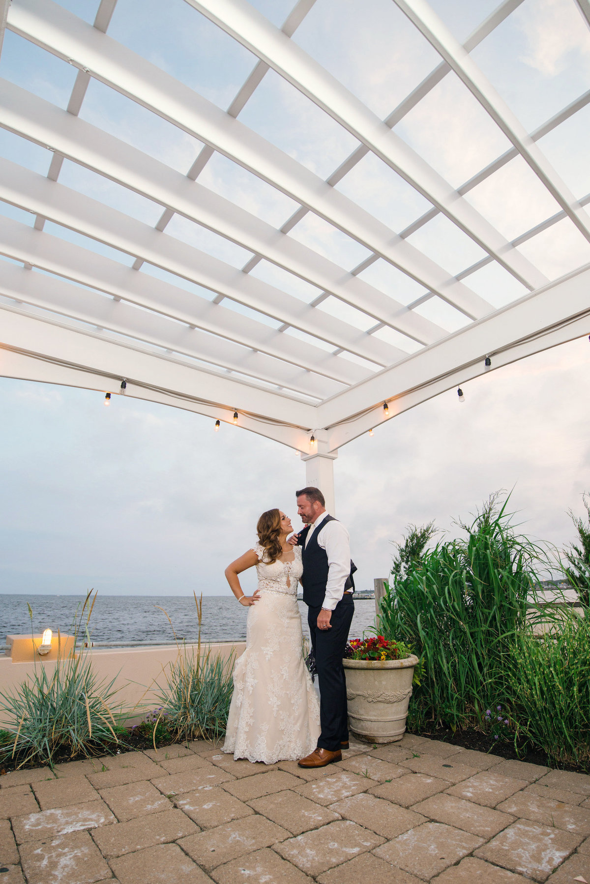 photo of bride groom on the outdoor courtyard from wedding Lombardi's on the Bay