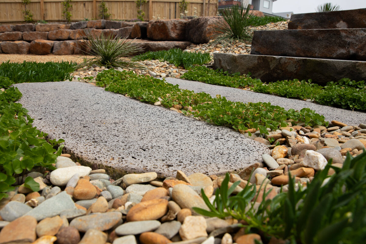 Landscape design using paving and rock work mixed with greenery for this garden