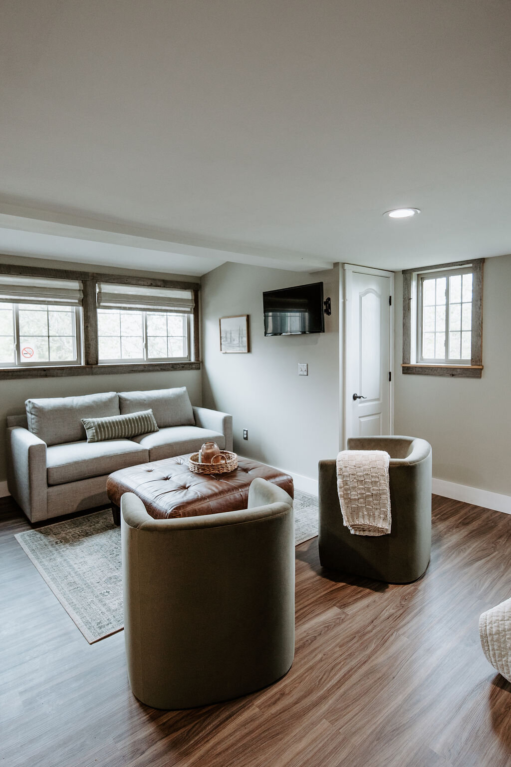 the green velvet barrel chairs and Crate & Barrel couch in the second floor studio overnight suite at Willowbrook wedding venue in Pittsburgh