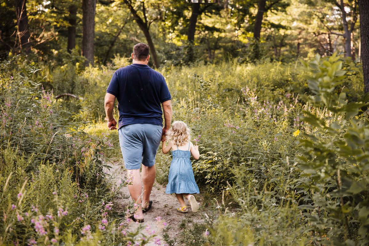 Father and daughter walking through wildflower path in Toronto Park