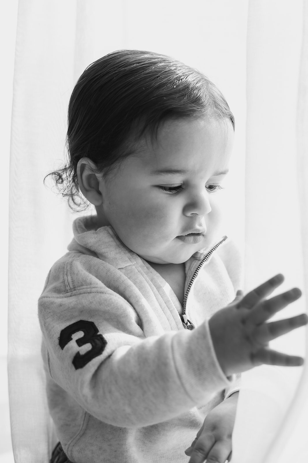 A baby boy is in a quarter zip.