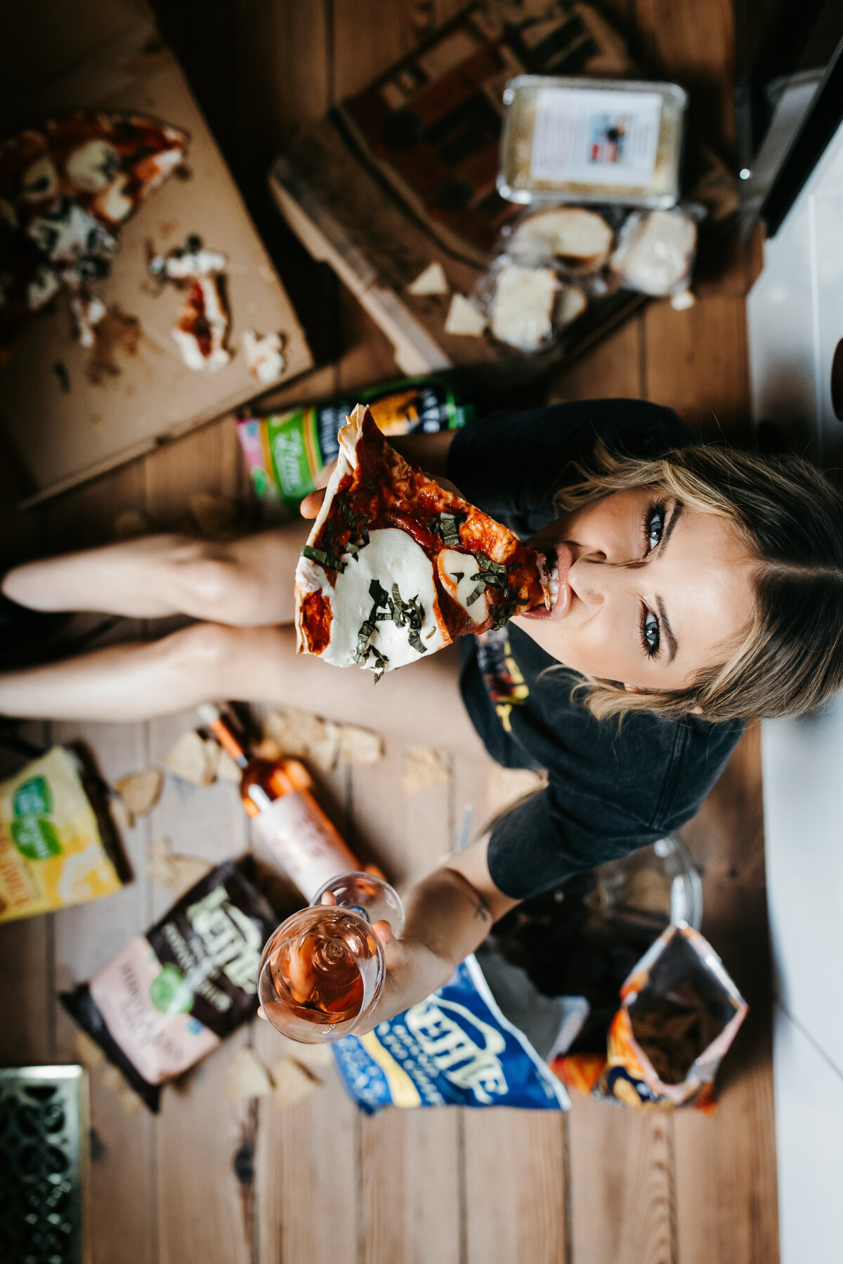 Kaitlyn Bristowe Spade & Sparrow photoshoot sitting on the floor eating pizza and chips
