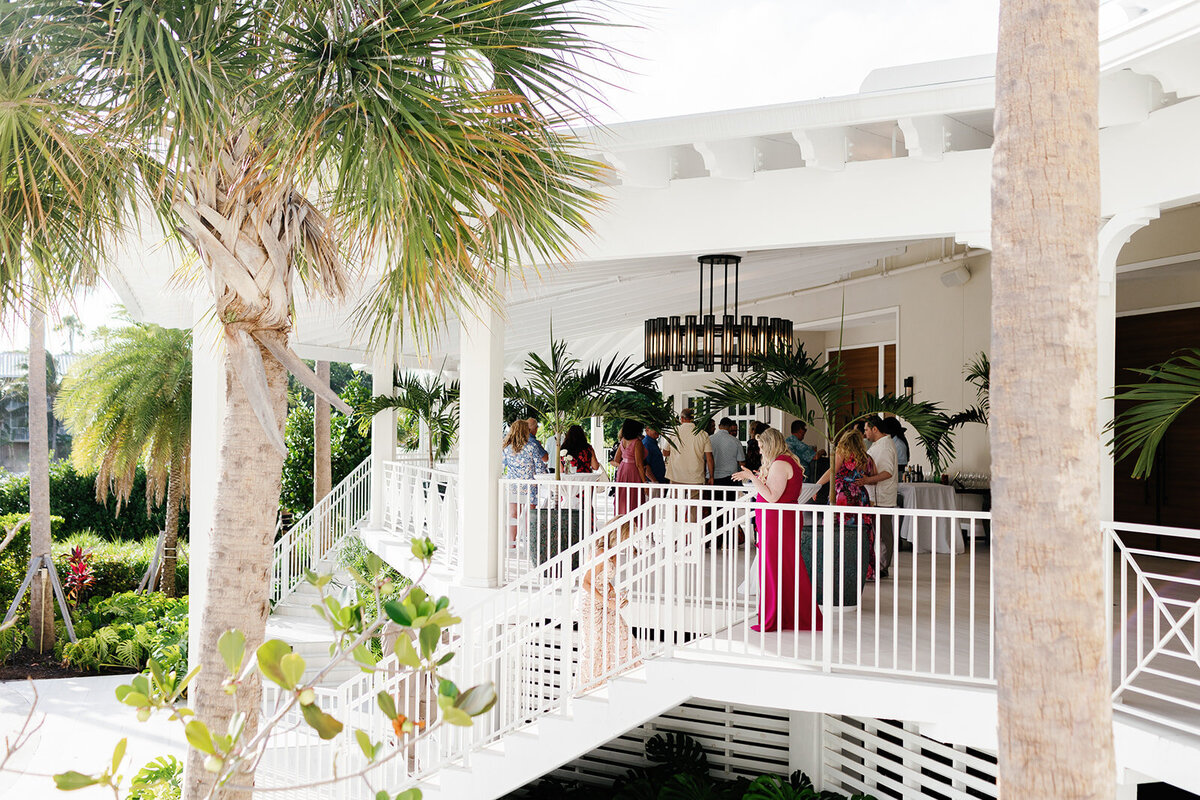 Another cinematic view of bridesmaids in flowing dresses walking down the Cheeca Lodge staircase.