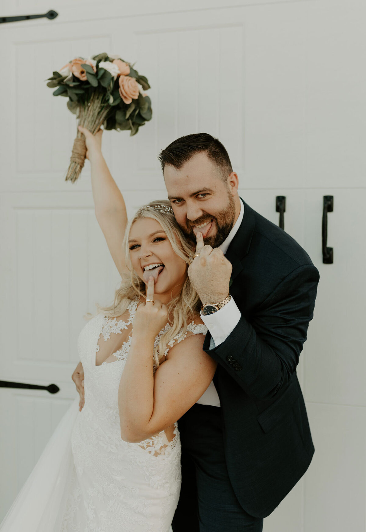 bride and groom showing off rings