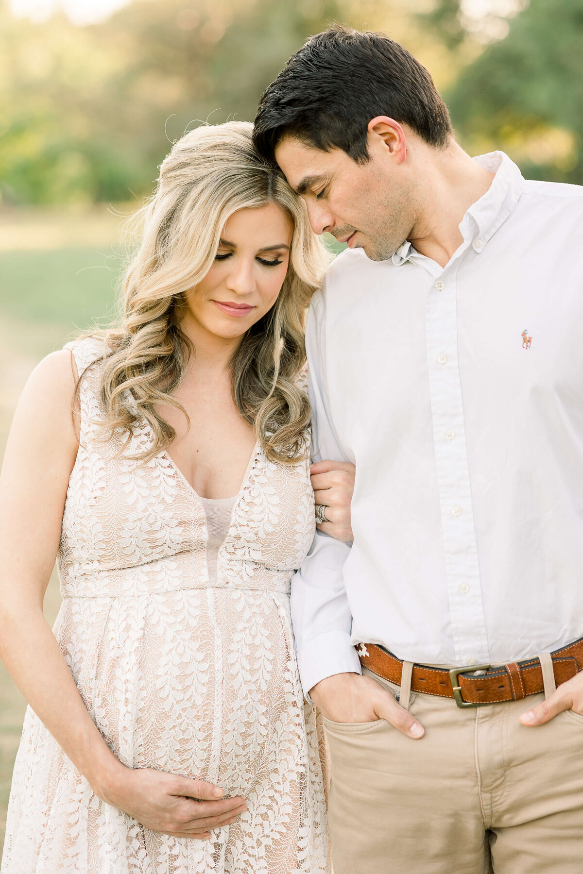 an expecting couple embracing