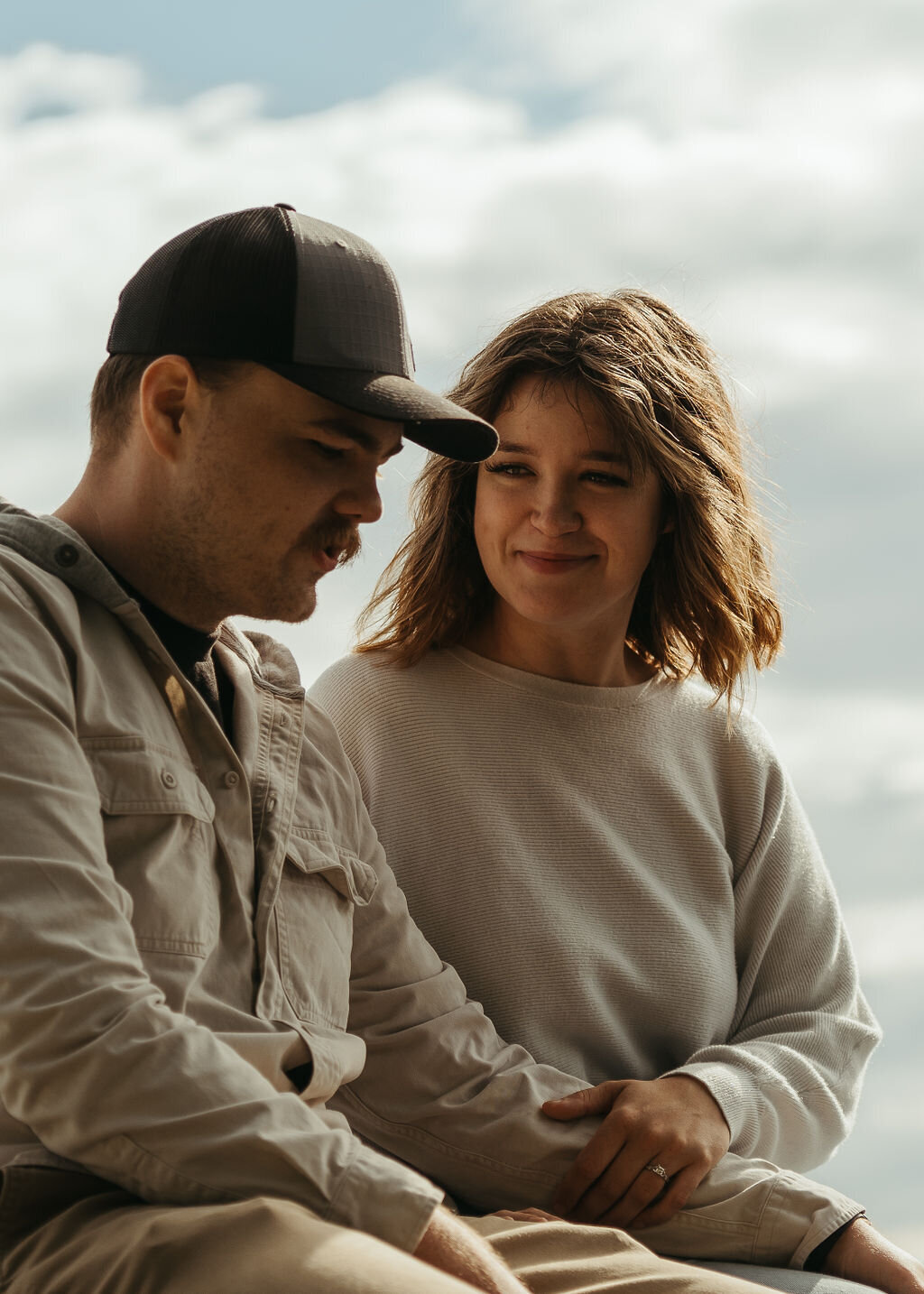 Photo of woman admiring fiance as he talks
