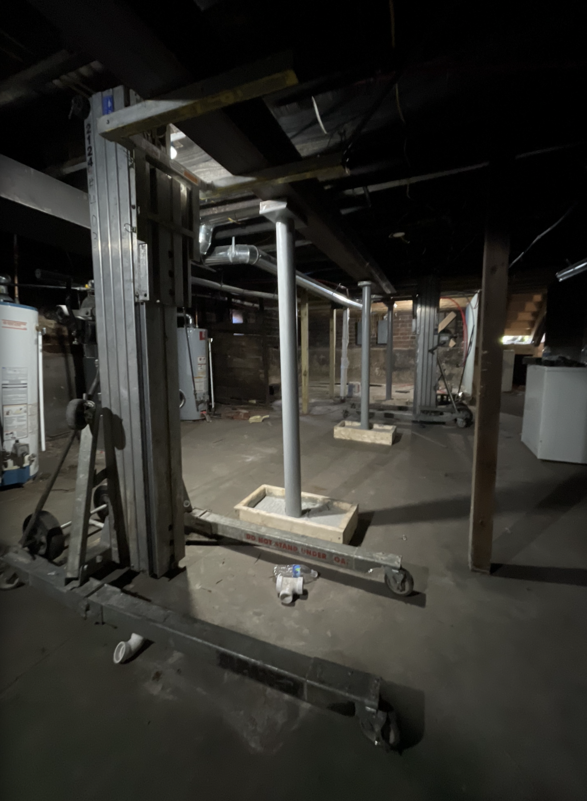 Welded steel columns installed in a residential basement to provide structural reinforcement and added support.