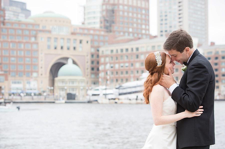 boston harbor hotel wedding couple with skyline background