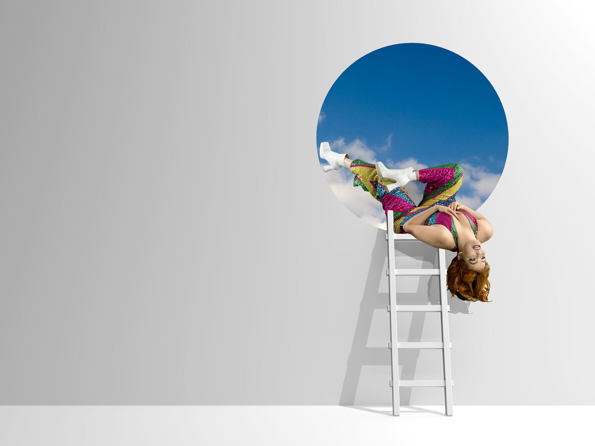 Eden Prairie Minnesota creative senior photo of girl in studio with on ladder falling from the sky