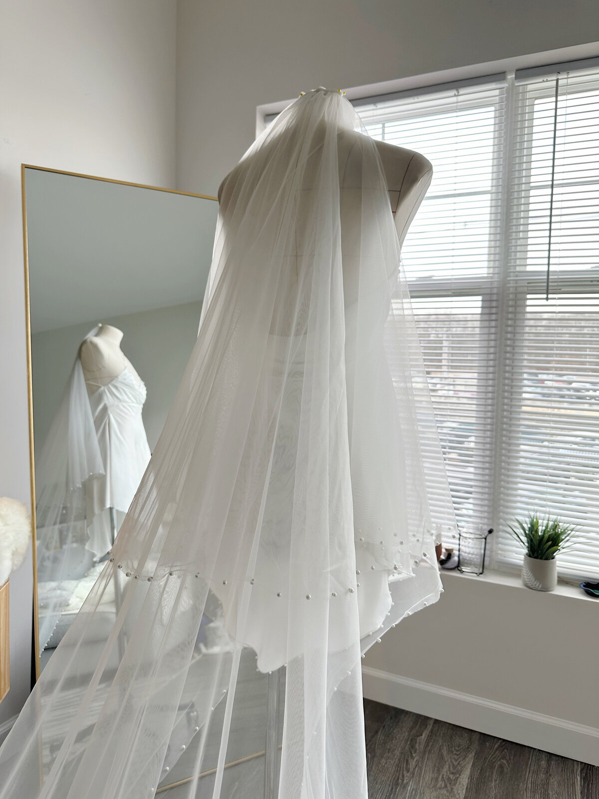 Elegant bridal look featuring lace-trimmed blusher veil
