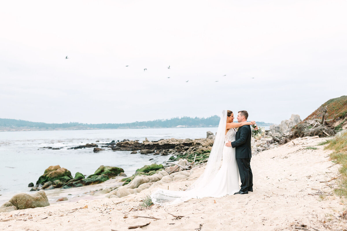 Couples poses on Carmel Beach for their Wedding