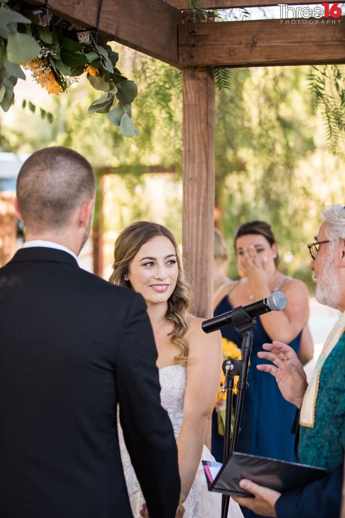 Rabbi speaks as the Bride looks at him
