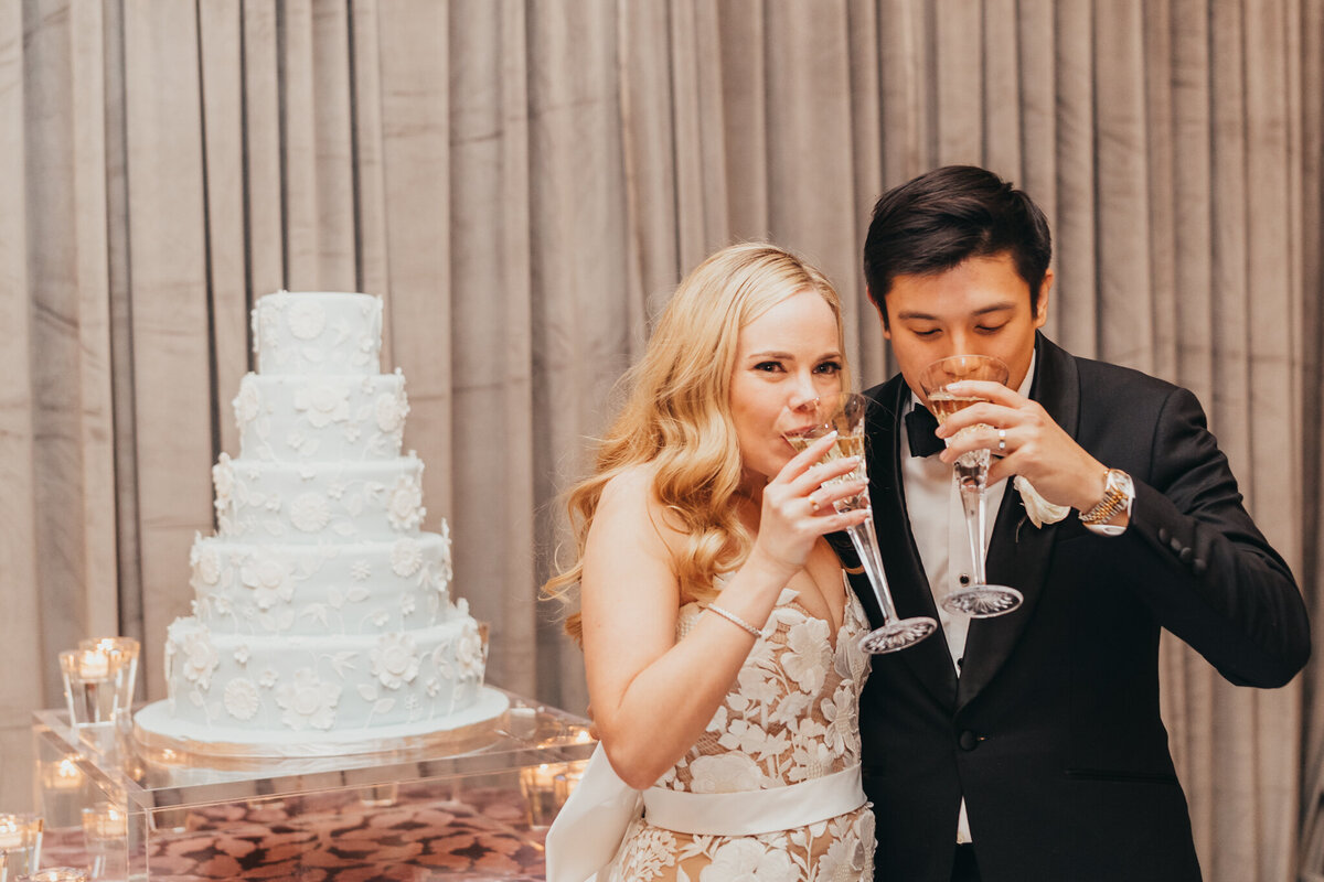 bride and groom drink champage after cake cutting.