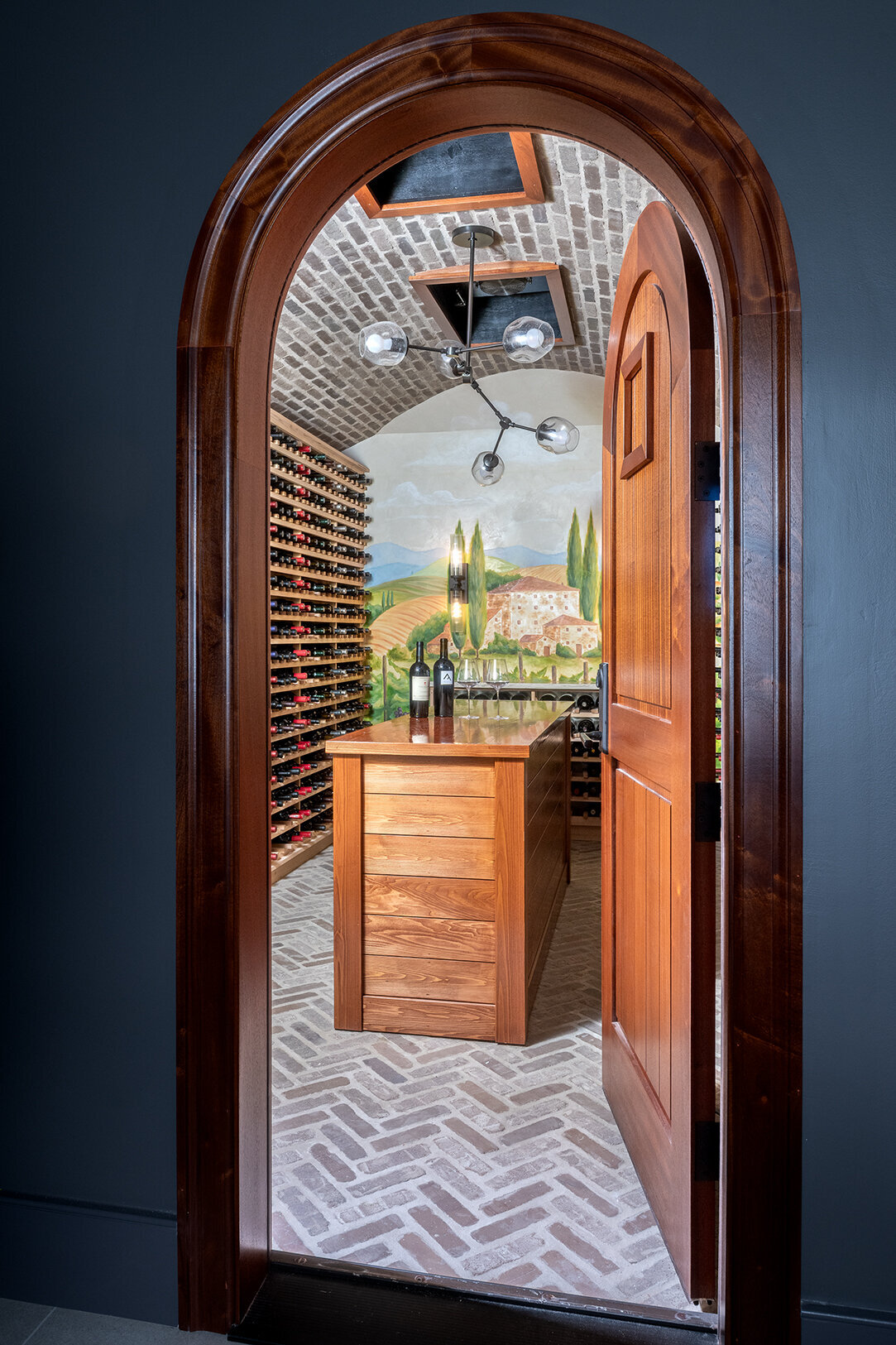 open door to tan wood wine cellar 