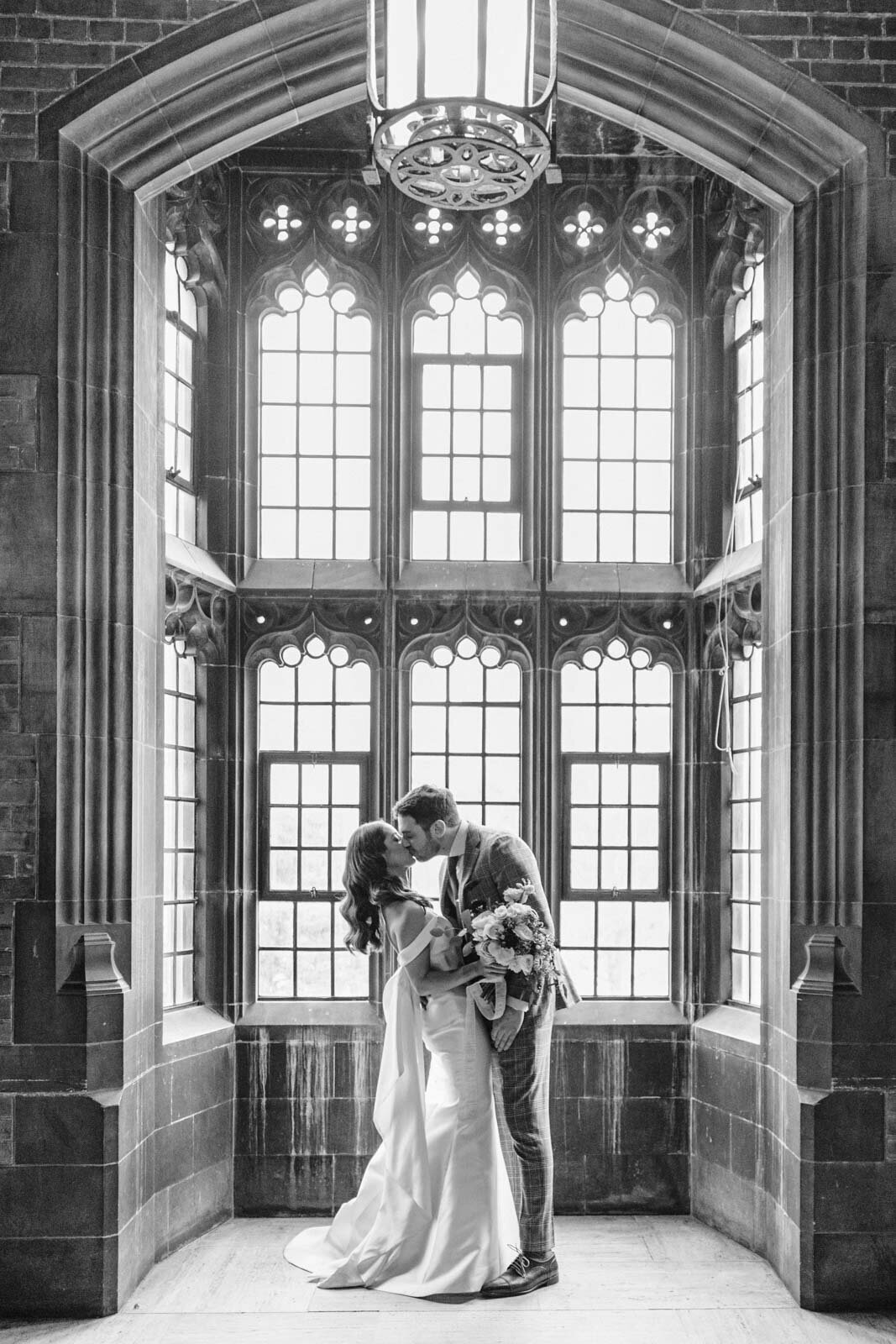 Beautiful romantic image of bride and groom in a bay window captured by a Calgary Wedding Photographer