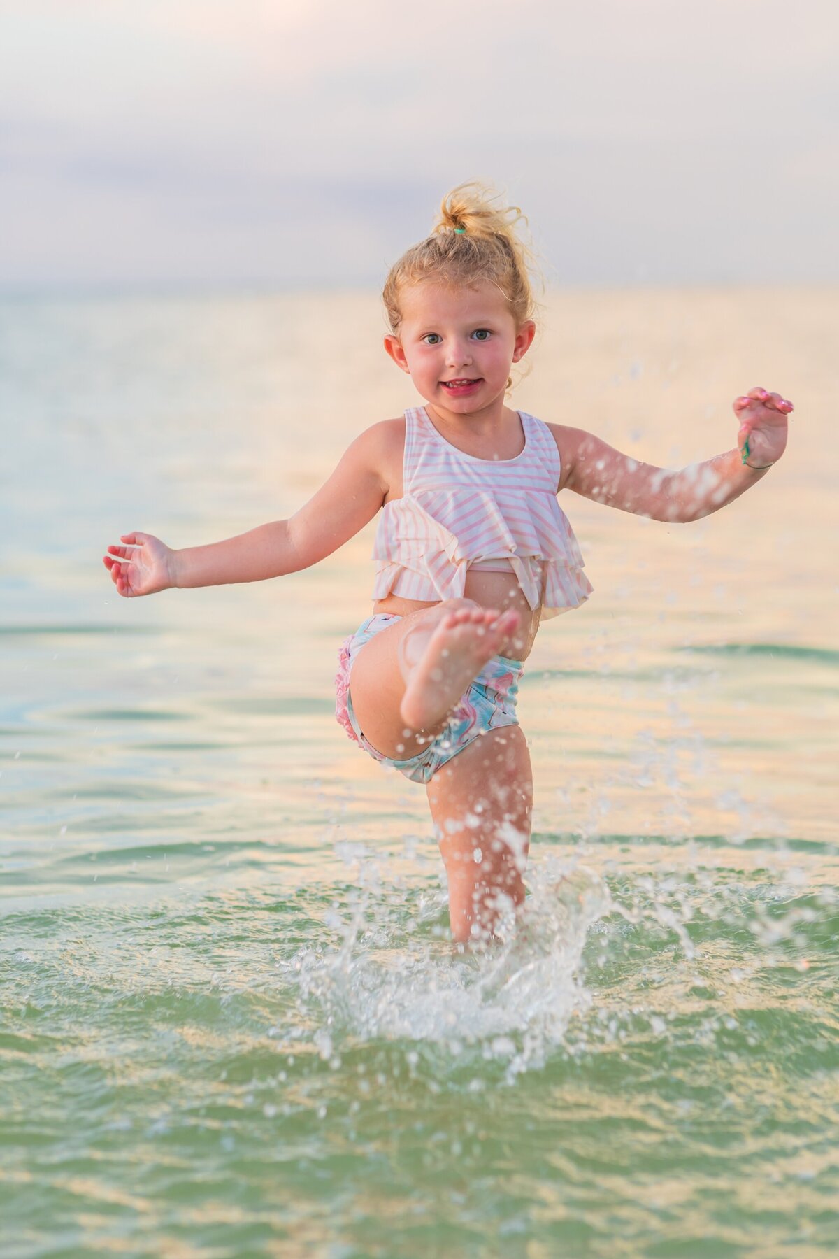 Little girl splashing in the water on an Anna Maria Island Beach